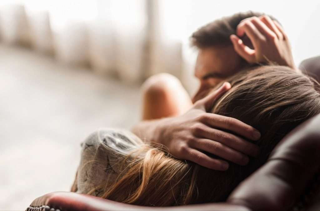 couple cuddling on the couch